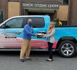 Mohawk House owner Steve Scro with Vernon Senior Center’s Mishelle Downtain, donating food to the senior center in October.