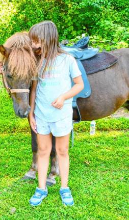 Hope Dowd of Hamburg communes with a pony.