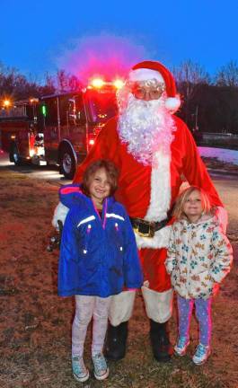 Bianca and Alexsa Raperto pose with Santa.