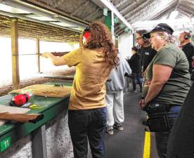 Tessa Boulac-Geleski fires a .22 caliber rifle as Vanessa St. Clair coaches her. (Photos provided)