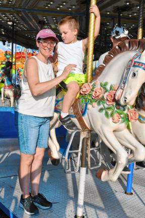 <b>Theresa and Logan Curry of Andover on the merry-go-round. (Photo by Maria Kovic)</b>