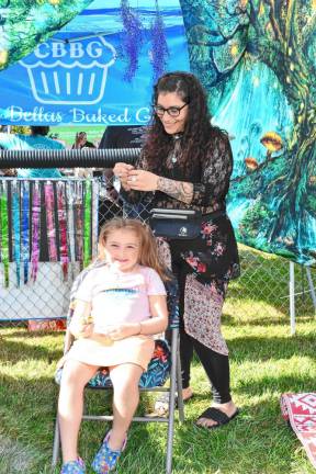 <b>SF2 Sadie Colbath has her hair done at the festival, sponsored by the Stanhope Home &amp; School Association.</b>