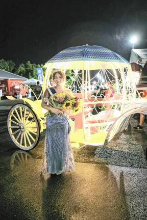 <b>Miss Lafayette Chaya Ortega, who was crowned 2024 Queen of the Fair, in front of her carriage.</b>