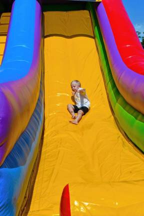 Enzo Brancaccio of Hamburg slides down an inflatable Sunday, Aug. 25 at Hamburg Day 2024. (Photo by Maria Kovic)