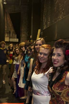 Models and designers wait backstage before the fashion show.