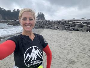 SW1 Retired Hamburg School teacher Suzanne Williamson is all smiles as she reaches the Pacific Ocean. (Photo courtesy of Suzanne Williamson)