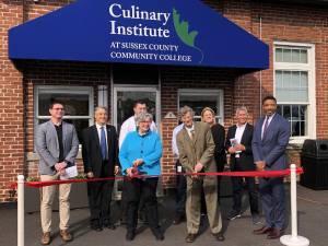 Officials gather for a ribbon-cutting at Sussex County Community College’s Culinary Institute in Newton on Thursday, April 27. Holding the scissors are the Hon. Lorraine Parker, former chairwoman of the SCCC board of trustees, and Jon Connolly, the college president. (Photos by Kathy Shwiff)