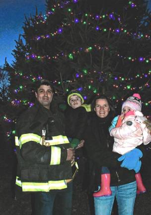 Corey, Andrew, Jenna and Lily Houghtaling in front of the Christmas tree in Franklin.