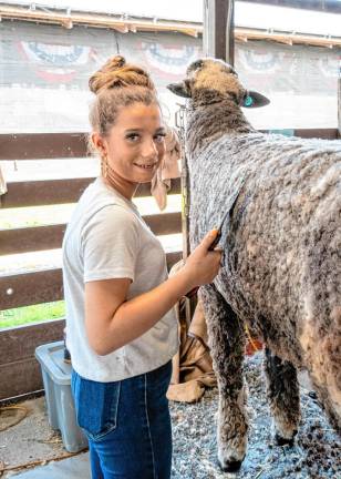 <b>Alexis Younglas grooming Manny. (Photo by Nancy Madacsi)</b>