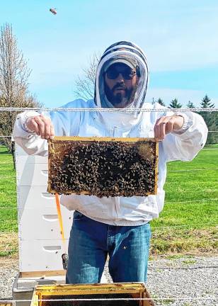 <b>Mike Richards started beekeeping when his son became interested in the hobby. The family now has nine hives.</b>