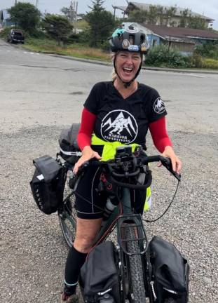 Retired Hamburg School teacher Suzanne Williamson is all smiles as she reaches the Pacific Ocean.