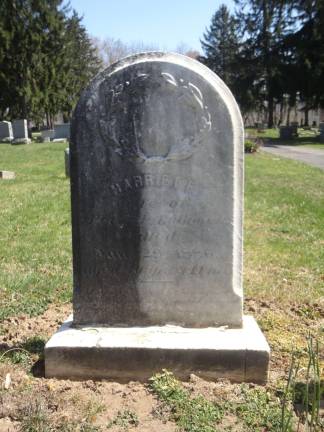 The second part of the DAR's mission was to clean the fungus off the old gravestones. Here, half of DAR member Lisa Permunian's ancestor Harriet F. Babcock's stone has been cleaned with a safe and effective solution called D/2.