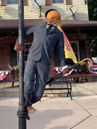 A pumpkin scarecrow dressed as the Gene Kelly character in the movie ‘Singing in the Rain is on display in Branchville this month.