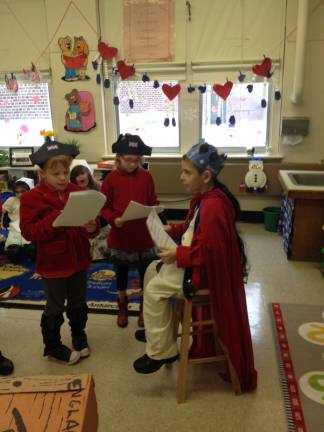 Nicole Kroger, Chloe Fedder and Francis Gunderman re-enact the King of England's role in the Boston Tea Party.