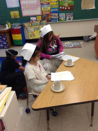 Catherine VanTassel and Evelyn Slater re-enact the Boston Tea Party.