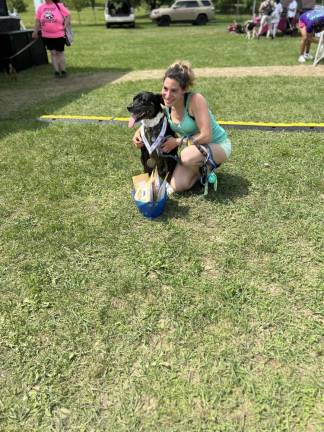 Bella, posing with owner Allison Koenigsberg, took first place in the peanut butter eating contest.