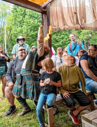 Daniel GreenWolf demonstrates fire eating at the testival, which runs for two more weekends.