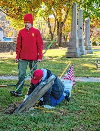 Xavier and Blaise Franko repair a leaning headstone in the graveyard behind the Sparta Presbyterian Church. Xavier is assistant senior patrol leader of Troop 95.