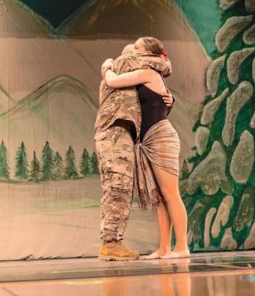 HH1 1st Sgt. James McGoonan of Wantage hugs his daughter Dona during the annual holiday performance of Dance Expression Dance Arts on Dec. 7. In honor of Pearl Harbor Day, the show concluded with a performance to ‘I’ll Be Home for Christmas’ dedicated to those serving in the U.S. military. (Photos by Geo Kumetz)