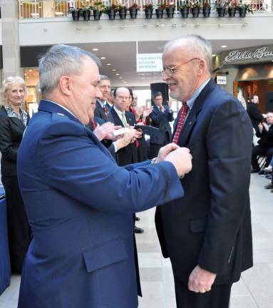 William K. Pochettino, Hamburg, is pinned with the Distinguished Service Medal by Brig. Gen. Michael L. Cunniff, for service during the Vietnam War. Approximately 15 New Jersey veterans from various war conflicts were honored and bestowed with the state's top military awards during a medal ceremony at the Veterans Outreach Campaign program at the Bridgewater Commons Mall on March 6. With Lt. Gov. Kim Guadagno, Brig. Gen. Michael L. Cunniff, the Adjutant General, and Raymond L. Zawacki, Deputy Commissioner of Veterans Affairs, present at the ceremony, each medal receipient was presented with their respective medals in front of more than 50 family, friends and community leaders. (Photo by Staff Sgt. Armando Vasquez, NJDMAVA/PA)