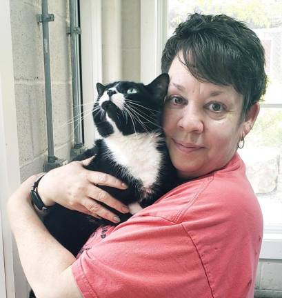 West Milford Animal Shelter Society secretary Paula Whritenour cradles Ghost, one of the many cats available for adoption.