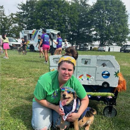 Elena Philolius poses with Packers the grateful dog, who won first place in the costume contest.