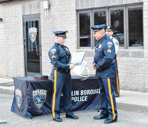 BU2 Sgt. William Grissom presents a plaque to Sgt. Rafael Burgos, who is retiring after 26 years with the Franklin Borough Police Department.