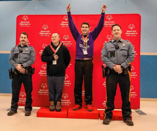 Hardyston Police Officers Jared Kodis, left, and Justin Edelbach, right, with speed skaters Joseph Pilchuk and Robert Lieu.