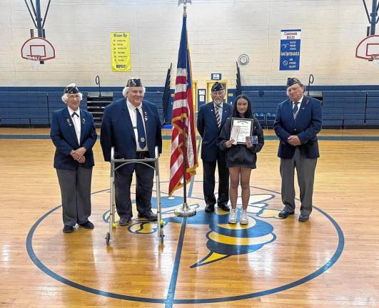 Hardyston Middle School student Clarisse Simbulan holds a check and silver medal for taking second place in the state American Legion Coloring Contest. With her are Sussex County 2nd Vice Commander Monica Flynn, County Commander John Hanson, Sgt. Francis M. Glynn Franklin American Legion Post 132 Chaplain Robert Caggiano and past Post 132 Commander John Hanson. (Photo provided)