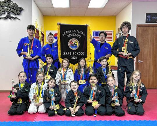 Master Ken’s Xtreme Martial Arts Center in Hamburg was named the best school at the U.S. Hong Ik Taekwondo Championship at Queens College. Students in the first row, from left, are Lianna Mehmedi of Hardyston, Natalia Daronco of Wantage, Annastasia Rodriguez of Sparta, Reed Bourne of Wantage, Alex Lorenzo of Franklin, Sophie Sylvestri of Wantage and Gina Campa of Hardyston. In the second row, from left, are Jake Klein of Hamburg, Timmy Lorenzo of Franklin, Lincoln Luedtke of Hamburg, Mirae Lee of Hamburg, Matthew Ciccone of Hardyston and Lucio Campa of Hardyston. Holding the flag are Nathan Henry, left, and Evan Zhang.