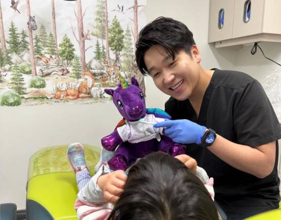 Smile Hero’s Dr. Jackson Jeong uses a stuffed animal to show a patient proper bushing techniques.