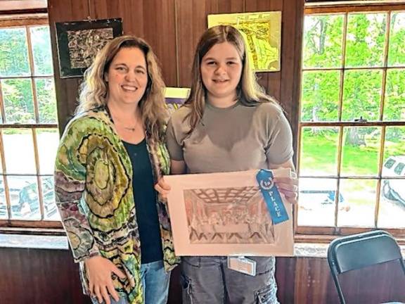 Ogdensburg School art teacher Wendy Ransom poses with eighth-grader Cassidy Lairson, who won first place for her artwork, ‘The Cat Supper.’
