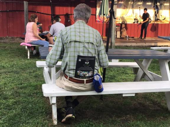 A tour-goer keeps reading material handy at the after party.