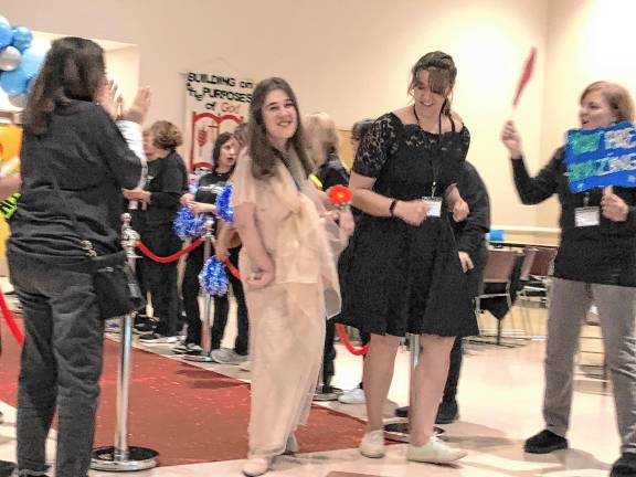 <b>Volunteers welcome a guest and her buddy walking the red carpet into the prom last year at St. Francis de Sales Church in Vernon. (Photos by Kathy Shwiff)</b>