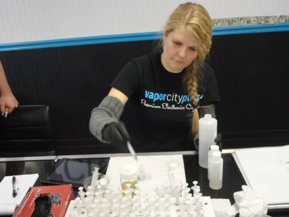 Dawn Krause of Wantage, mixes a customer's bottle of e-liquid.