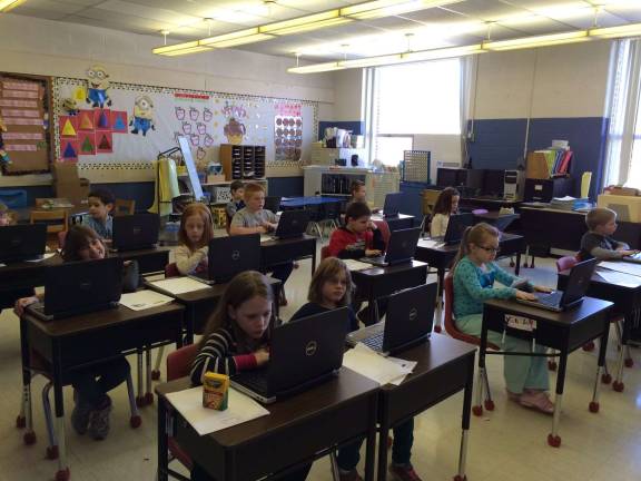 Kimberly Ivanaov&#x2019;s second-grade class working on the new laptops.