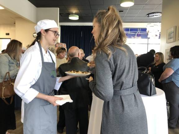 A Sussex County Communty College student serves hors d’oeuvres after the ribbon-cutting ceremony at the college’s new Culinary Institute.