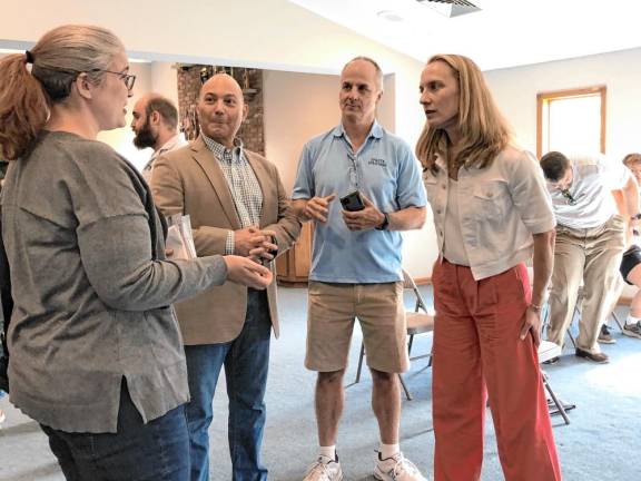 Sue Altman, right, talks to a resident after a town hall meeting Saturday, Oct. 6 in the Sparta Ambulance Squad building. With them are Sparta Deputy Mayor Dean Blumetti, second from left, and Councilman Daniel Chiariello. (Photos by Kathy Shwiff)