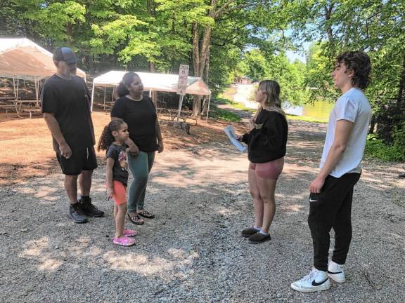 Counselors Mia and Michael Harrison, right, give Cesar and Kenia Gomez and their daughter Kacey, 5, a tour of the Bubbling Springs Day Camp in West Milford. Kacey is signed up for five of the seven weekly sessions this summer. The camp held an open house Saturday, June 1. (Photos by Kathy Shwiff)