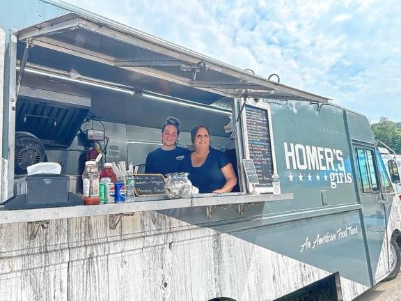 Vanessa Wainio and her mother, Donna, in the Homer’s Girls food truck. Vanessa owns the food truck with her sister Amanda Wainio-Viegas. Donna was helping her daughter. (Photo by Daniele Sciuto)