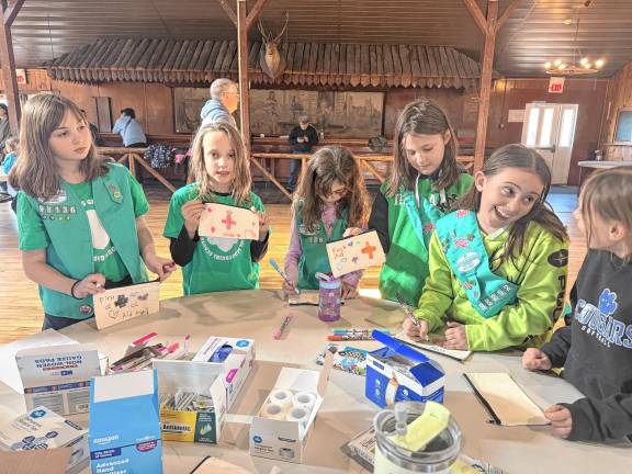 Girl Scouts make first-aid kits during the first Girl Scout First Aid and Safety Award event March 8 in Andover Township. (Photos provided)