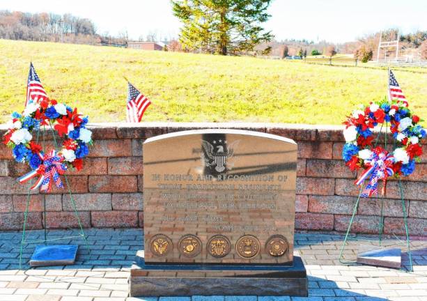 Wreaths are placed by a memorial outside the municipal building.