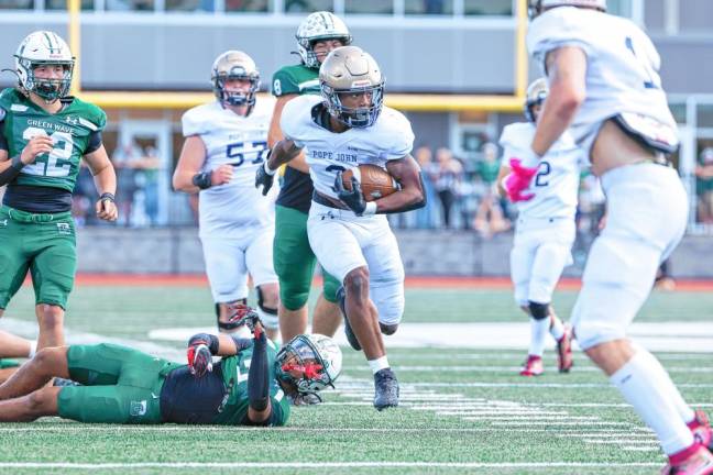 <b>Tylik Hill of Pope John looks to his left after breaking a tackle on a run from scrimmage in the first quarter of the game at Delbarton.</b>