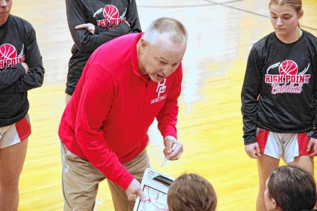 High Point girls basketball coach Gary Ruban instructs players during a break.