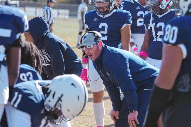 Sussex Skylanders head football coach James Robertson talks to players during a break.