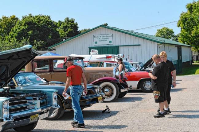 <b>Residents look at entries in the Frankford Township Car Show on Aug. 25 at the Sussex County Fairgrounds. The show benefited Father John’s Animal House. (Photos by Maria Kovic)</b>