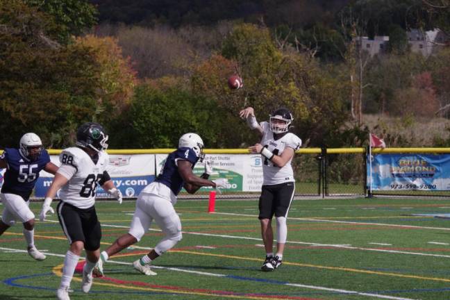 Hudson Valley quarterback Cameron Harbaugh throws the ball under pressure. (Photo by George Leroy Hunter)