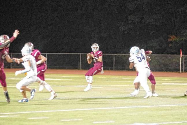 <b>Newton quarterback Matt Ellsworth scans the field for an open receiver. He threw one touchdown pass in the game.</b>