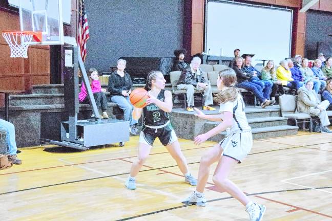 Veritas's Eileen Dorrity is in possession of the ball. She grabbed one rebound, made two assists and was credited with one steal.