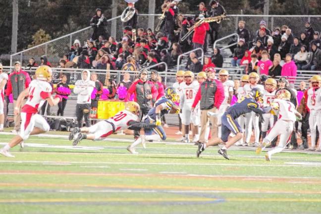 <b>A Vernon ball carrier is caught from behind by a Mount Olive defender.</b>